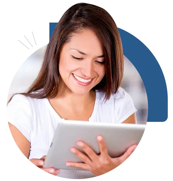 A woman is holding an ipad and smiling.