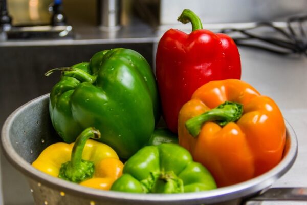 A bowl of peppers on the counter in a kitchen.